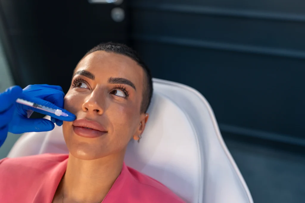 Woman on treatment table receiving lip treatment in Brooklyn, NY | Mrs. Webb Aesthetic